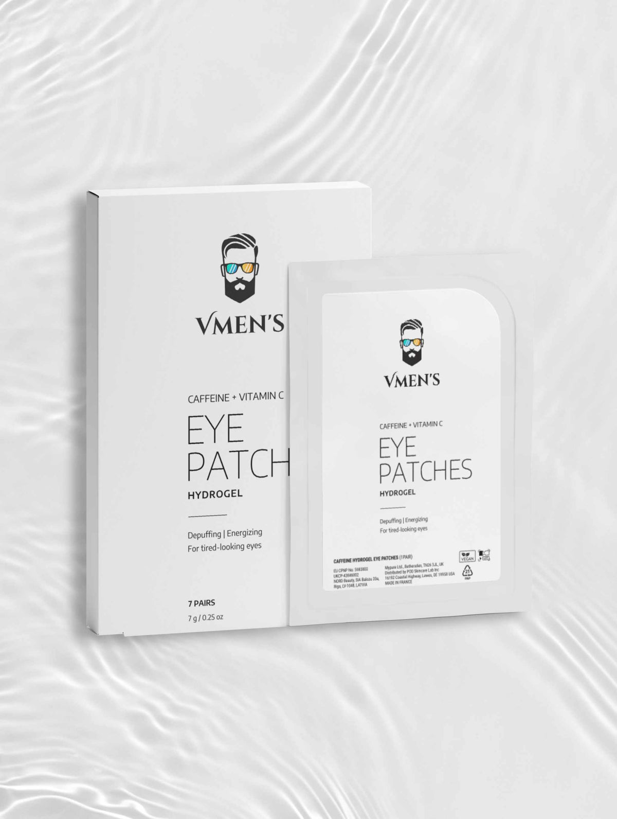 VMEN’S Caffeine + Vitamin C Hydrogel Eye Patches box and sachet on a white surface with rippling light.