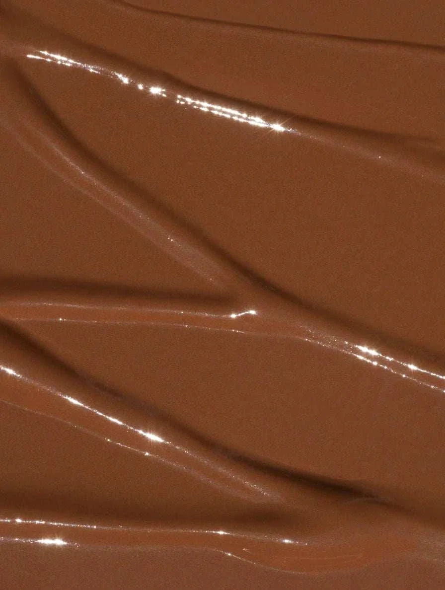 Creamy brown concealer in shade 35 Deep Neutral, with a smooth, reflective finish and soft texture for blending.