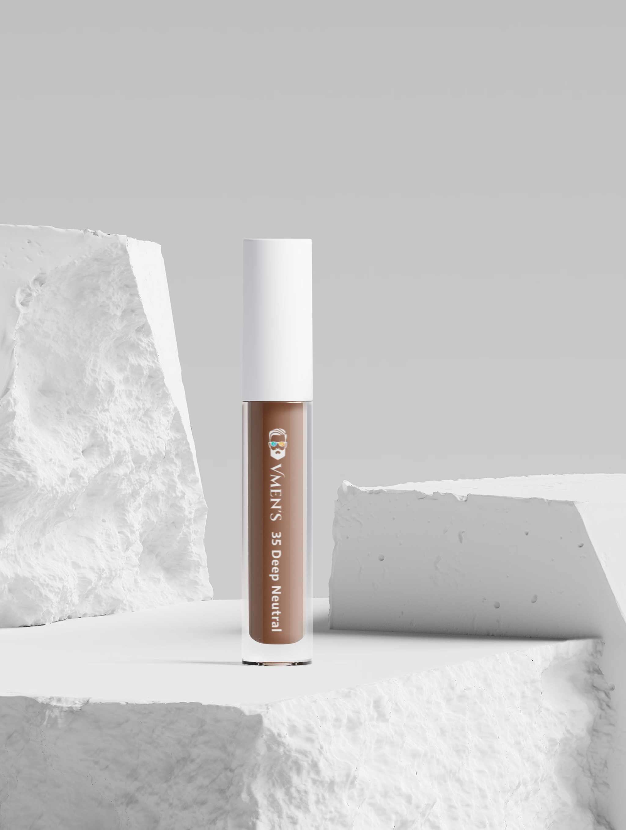 Correcting Concealer for Men in shade 35 Deep Neutral, in a clear tube with a white cap, positioned on textured white blocks.