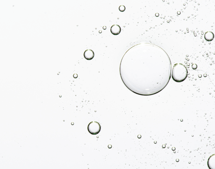 Glycolic Acid Liquid Exfoliator, a clear colourless fluid with suspended bubbles of varying sizes