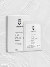 VMEN’S Caffeine + Vitamin C Hydrogel Eye Patches box and sachet on a white surface with rippling light.