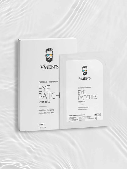 VMEN’S Caffeine + Vitamin C Hydrogel Eye Patches box and sachet on a white surface with rippling light.