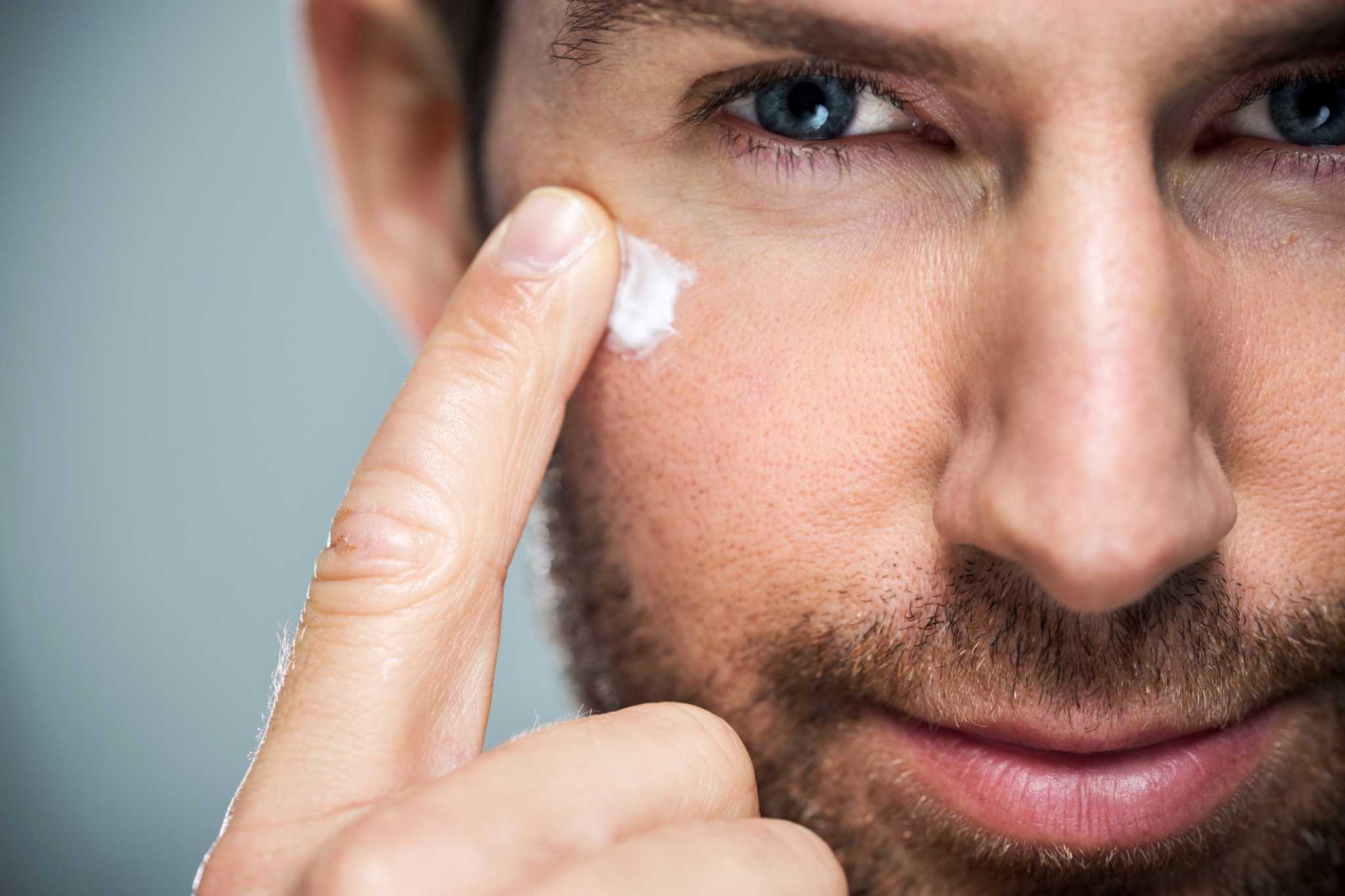 Man applying  Calming Eye Cream