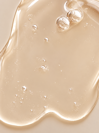 Close-up of VMEN’S Sensitive Scalp Shampoo for Men, showing a translucent golden gel texture with air bubbles.
