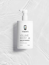 VMEN’S Keratin Volume Boost Shampoo on a white surface with rippling water reflections.