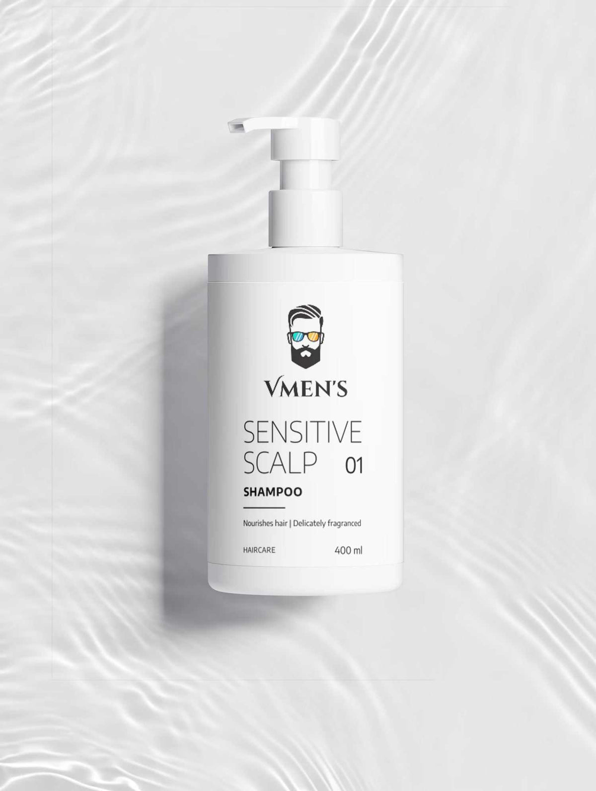 VMEN’S Sensitive Scalp Shampoo for Men on a white surface with rippling water reflections.