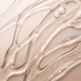 Close-up of the translucent golden gel texture of VMEN’S Moisturising Shampoo, with small bubbles.