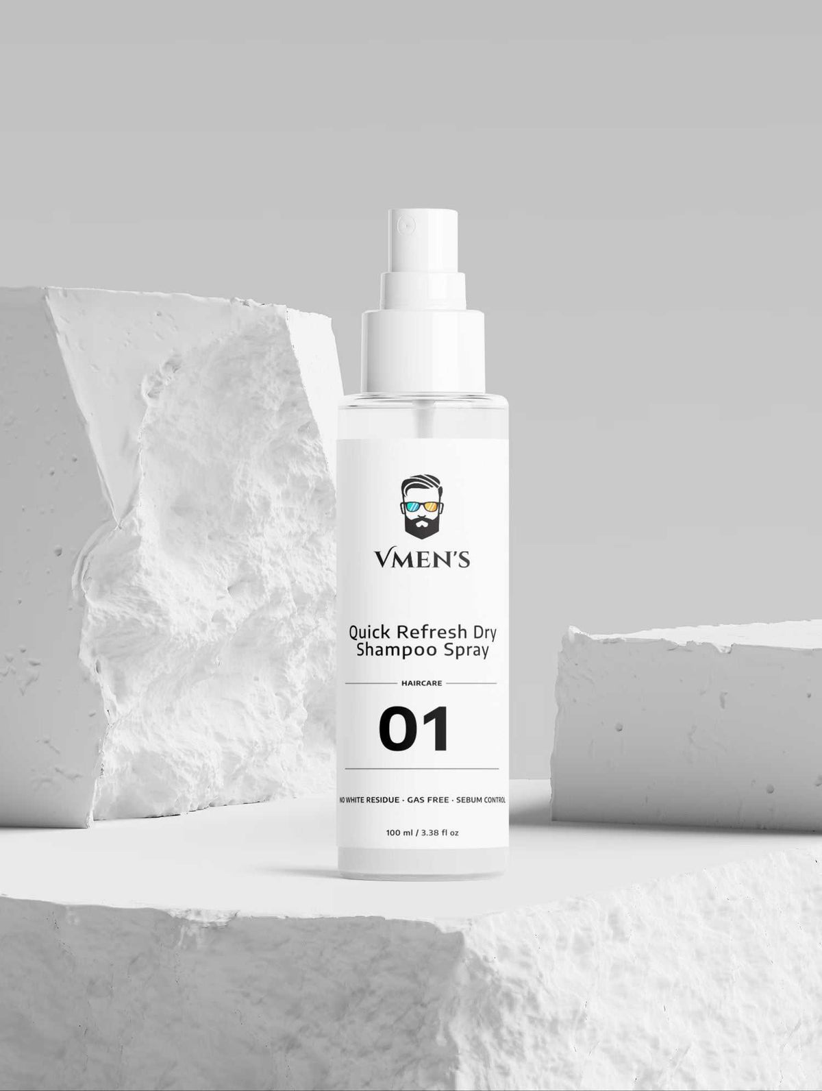 VMEN’S non-aerosol dry shampoo spray displayed on white stone blocks