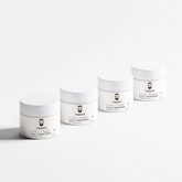 Four white jars of VMEN’S 3-in-1 Curly Hair Treatment for Men arranged in a row.