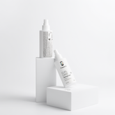 Front and back views of VMEN’S Anti-Frizz Curly Hair Texture Mist for Men bottles on white display blocks.