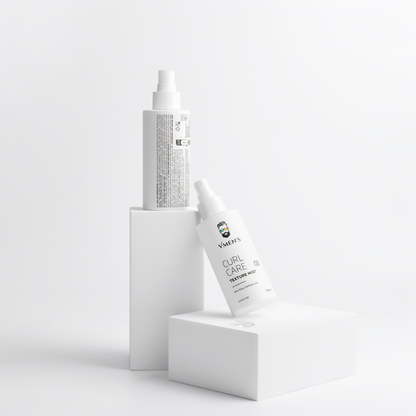 Front and back views of VMEN’S Anti-Frizz Curly Hair Texture Mist for Men bottles on white display blocks.
