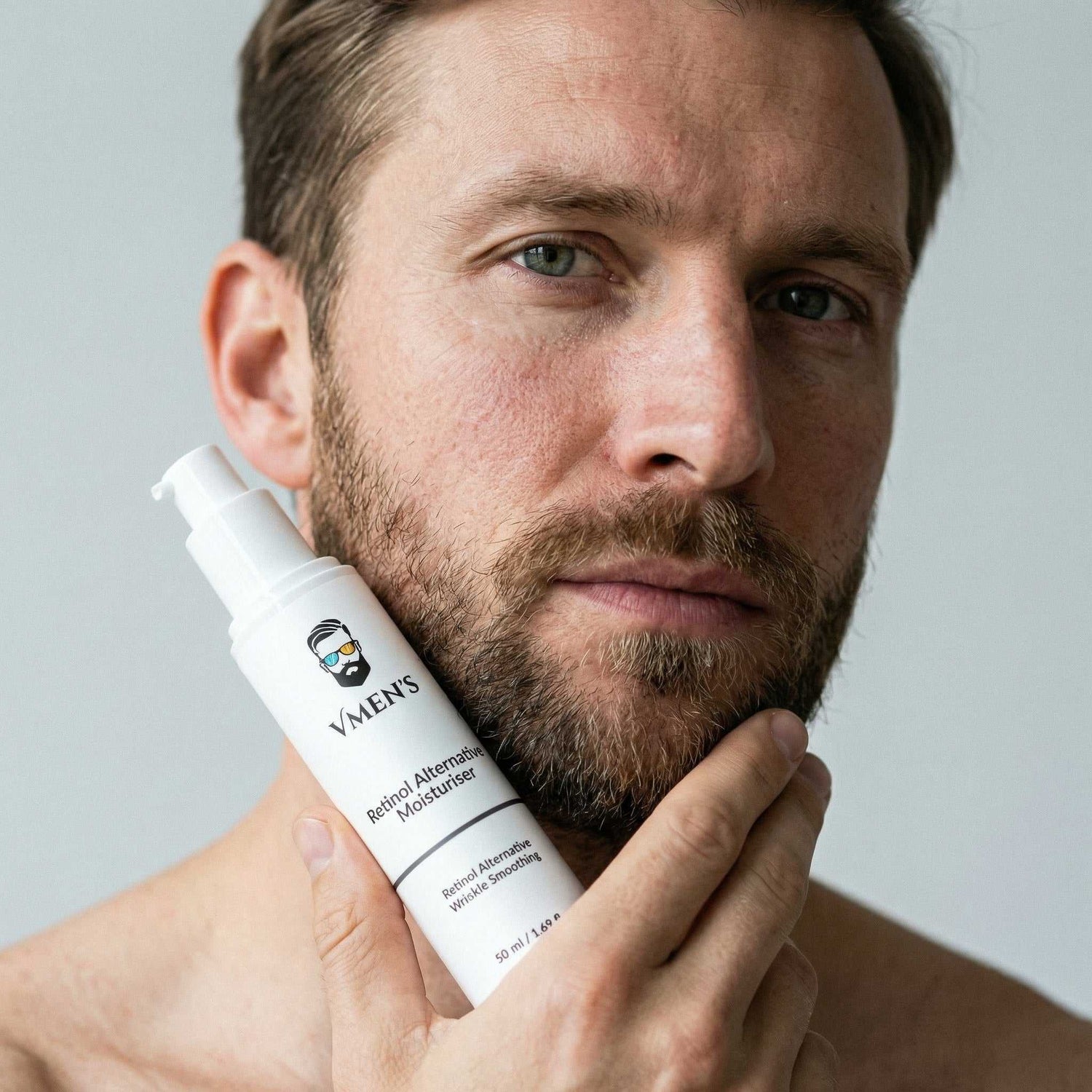 Man holding a bottle of men&