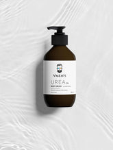 VMEN’S 5% Hydroxyethyl Urea + 2% Panthenol Body Cream on a white surface with rippling water reflections.