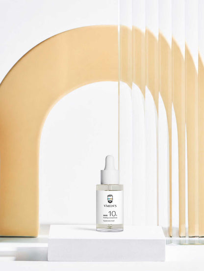 VMEN’S 10% Lactic Acid Peel dropper bottle on a white plinth beneath a golden arch.